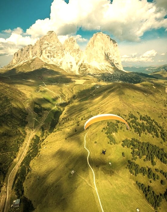 Paraglider in front of the Langkofel group of the Dolomites, Italy